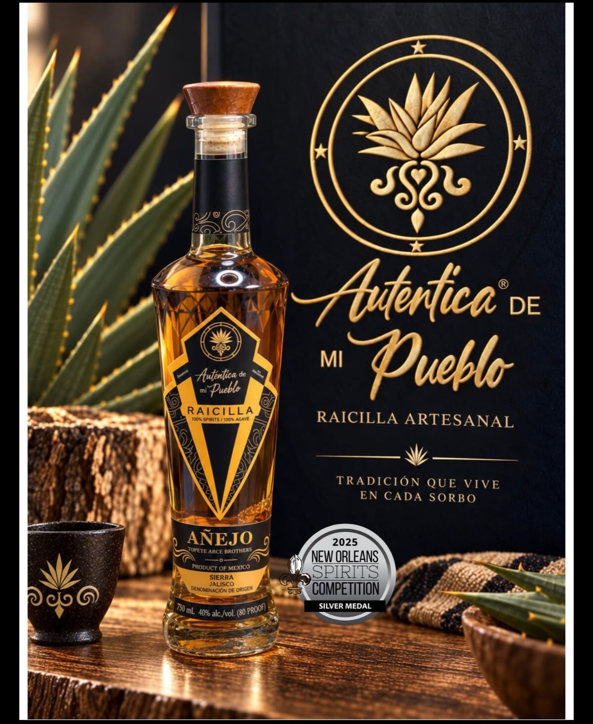 Bottle of Autentica de mi Pueblo anejo tequila displayed with agave plants and gold branding on black background